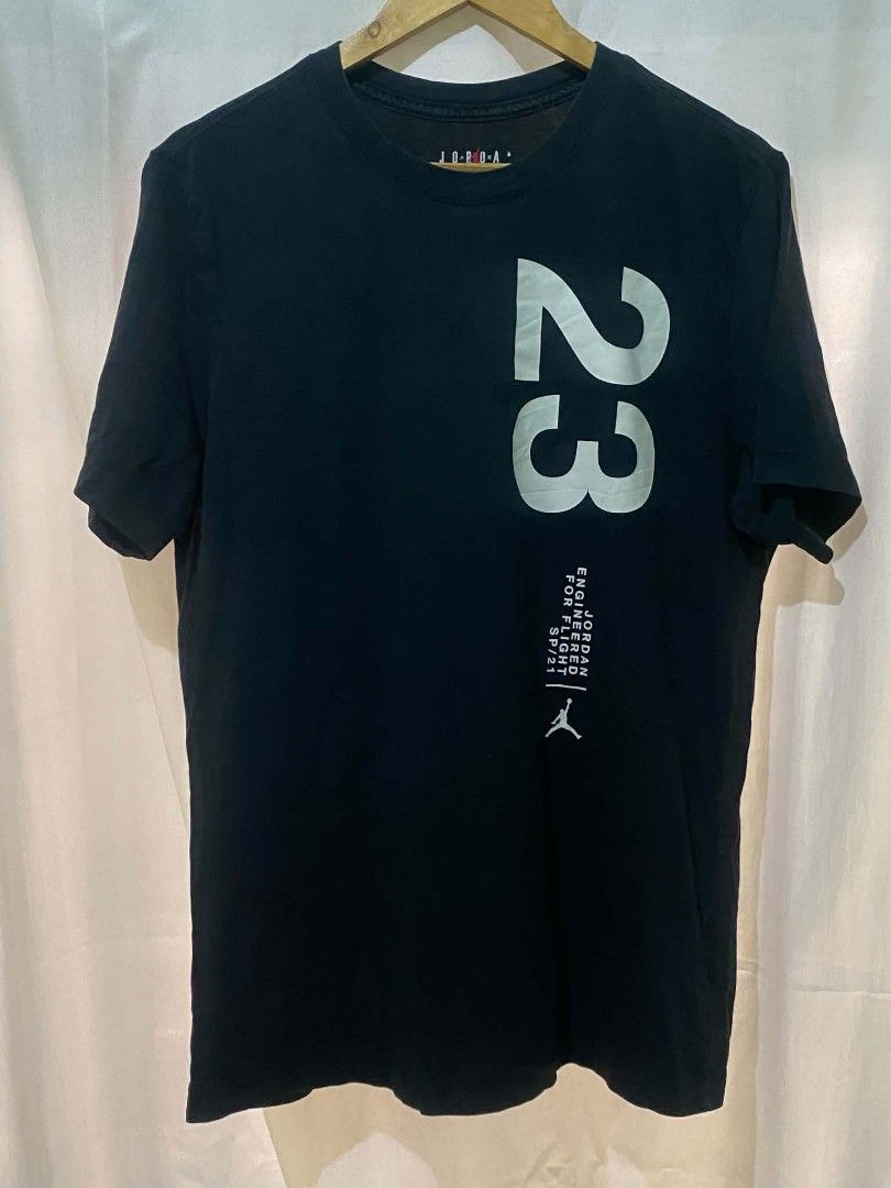 Jordan Engineered For Flight 23 T-Shirt Black (Category: Tshirts & Polo Shirts ) located in Quezon City. Submitted by elihur.tuazon (Listing ID 1469681865, Image 3). Description: - Authentic Jordan brand t-shirt - Color: Black with bold white graphics - Design: Large number 23 front and back, Jumpman chest logo, and 'Engineered For Flight SP/21' text - Back Graphic: Michael Jordan wireframe dunking in front of a yellow globe - Fit: Regular fit, c