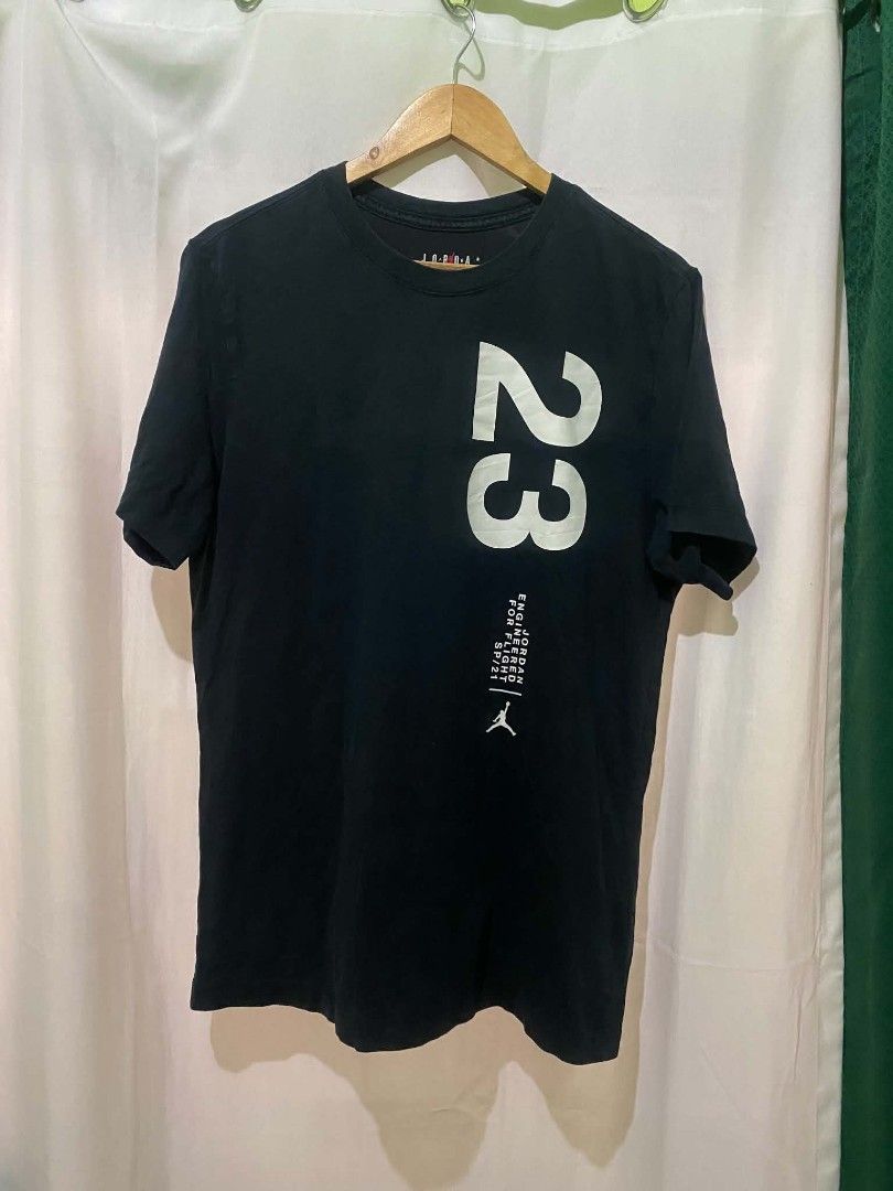 Jordan Engineered For Flight 23 T-Shirt Black (Category: Tshirts & Polo Shirts ) located in Quezon City. Submitted by elihur.tuazon (Listing ID 1469681865, Image 2). Description: - Authentic Jordan brand t-shirt - Color: Black with bold white graphics - Design: Large number 23 front and back, Jumpman chest logo, and 'Engineered For Flight SP/21' text - Back Graphic: Michael Jordan wireframe dunking in front of a yellow globe - Fit: Regular fit, c
