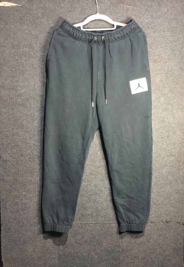 Jordan Jumpman Black Jogger Sweatpants Drawstring Cuffs (Category: Joggers) located in Manila. Submitted by thriftnipaps (Listing ID 1469686316, Image 1). Description: - Color: Dark grey with a contrasting black drawstring - Branding: Signature white Jordan Jumpman patch on the left thigh - Comfort: Soft fleece lining for warmth and cozy wear - Features: Two functional side pockets and snug ribbed ankle cuffs - Condition: Great for casual streetw