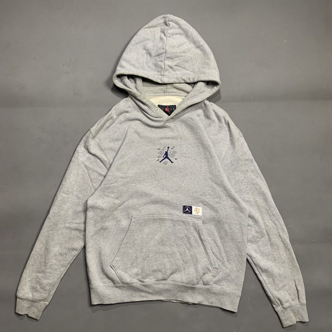 Jordan Jumpman Grey Pullover Hoodie with Pocket (Category: Hoodies) located in Kalibo. Submitted by gneiss2002 (Listing ID 1469597200, Image 1). Description: - grey Jordan pullover hoodie - Features small embroidered Jumpman logo surrounded by graphic clouds on the chest - Classic front kangaroo pocket with a small woven label - Soft and cozy fleece lining inside - Ribbed cuffs and hem for a snug fit - Flaw: Thick hood drawstrings are missing - G