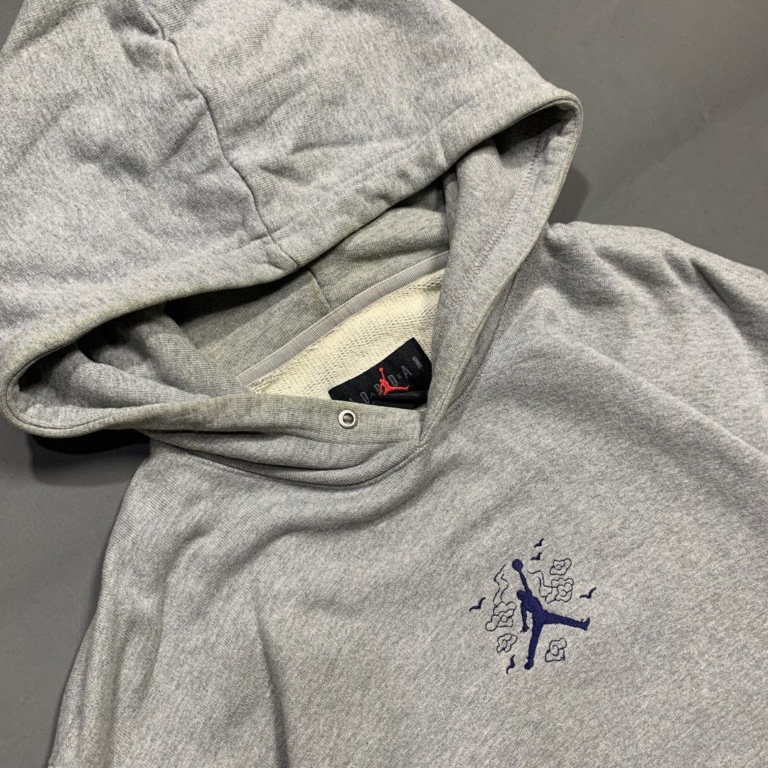 Jordan Jumpman Grey Pullover Hoodie with Pocket (Category: Hoodies) located in Kalibo. Submitted by gneiss2002 (Listing ID 1469597200, Image 3). Description: - grey Jordan pullover hoodie - Features small embroidered Jumpman logo surrounded by graphic clouds on the chest - Classic front kangaroo pocket with a small woven label - Soft and cozy fleece lining inside - Ribbed cuffs and hem for a snug fit - Flaw: Thick hood drawstrings are missing - G