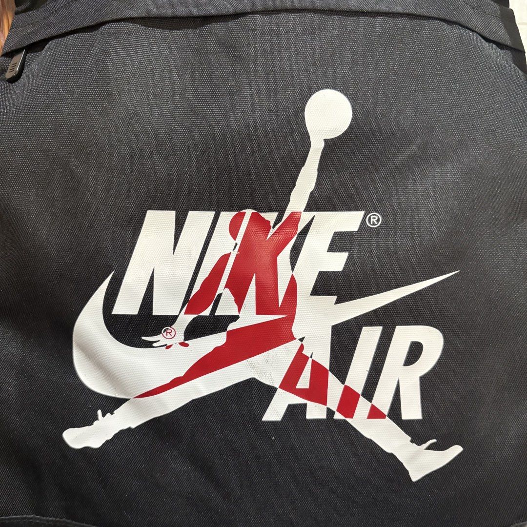 Jordan Nike Air Black Cinch Backpack (Category: Backpacks) located in Carmen. Submitted by rr_thrifts (Listing ID 1469686860, Image 2). Description: - Jordan Nike Air cinch backpack in classic black - Bold white and red Jordan Nike Air graphic on the front - Secure drawstring closure with convenient built-in grab handles - Adjustable shoulder straps and breathable mesh back panel for extra comfort - Subtle embossed Jumpman logo on the lower back 
