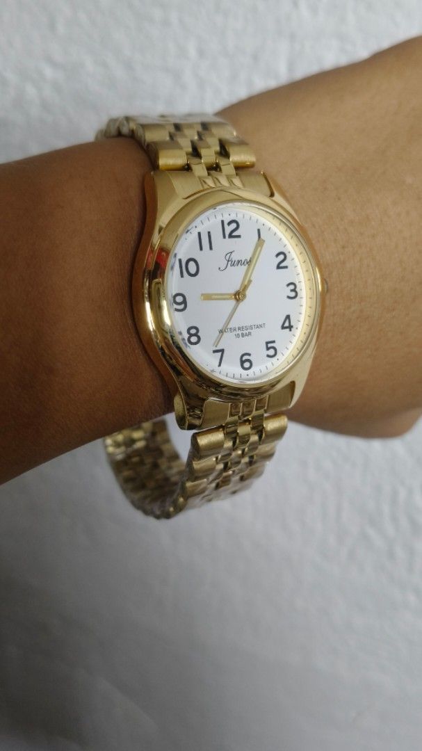 Junos Gold Tone Watch with White Dial (Category: Men's Watches) located in Taguig. Submitted by mercyeugen28914 (Listing ID 1469724168, Image 1). Description: - Elegant gold tone finish with a clean white dial - Easy-to-read black Arabic numerals and stylish gold hands - Classic Jubilee style metal bracelet - Reliable quartz movement - Water resistant up to 10 bar - Perfect classy and versatile look for daily wear or special occasions.