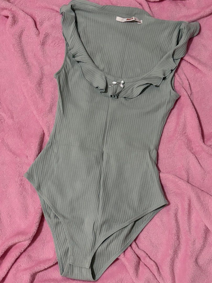Just G Light Blue Ribbed Ruffle Bodysuit Size M (Category: Sleeveless) located in Nagcarlan. Submitted by nkkva (Listing ID 1469690096, Image 1). Description: - Brand: Just G - Size: Medium - Color: Light Blue - Material: Stretchy ribbed knit fabric - Details: Scoop neckline, ruffle trim, tiny silver bow accent, sleeveless - Closure: Convenient snap closure underneath - Condition: Excellent, great basic piece for everyday pairing with jeans or sk