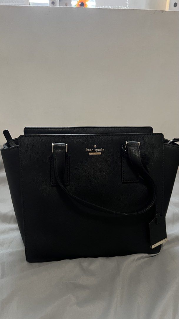 Kate Spade Cameron Street Small Hayden (Category: Luxury Bags & Wallets) located in Manila. Submitted by beas30 (Listing ID 1469630932, Image 3). Description: - Color & Material: Premium black leather with elegant gold hardware and logo lettering - Structure: Structured shape with dual top handles and a detachable shoulder strap - Interior: Chic black-and-white striped lining with a convenient zip compartment and brand tag - Closure: Secure zip-t