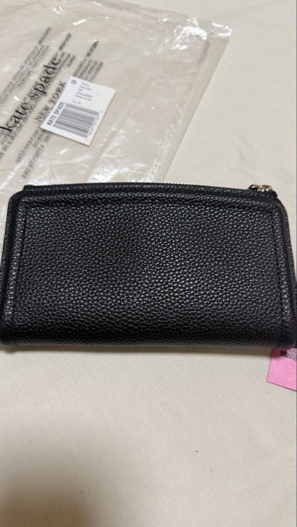 Kate Spade Knott Pebbled Leather Zip Slim Wallet Black (Category: Wallets & Card holders) located in Makati City. Submitted by mbcab (Listing ID 1469695617, Image 3). Description: Kate Spade Knott pebbled leather zip slim wallet in black. Model K5613. Genuine pebble leather construction with gold-tone hardware and spade logo. Interior features multiple card slots and snap closure compartments. Brand new with tags and original packaging including 