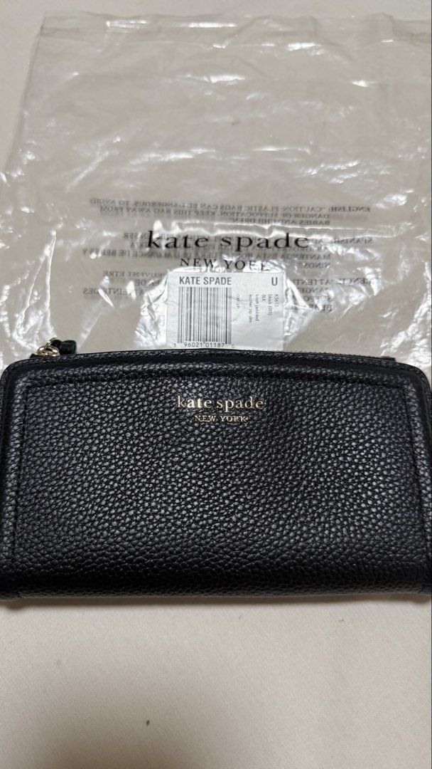 Kate Spade Knott Pebbled Leather Zip Slim Wallet Black (Category: Wallets & Card holders) located in Makati City. Submitted by mbcab (Listing ID 1469695617, Image 1). Description: Kate Spade Knott pebbled leather zip slim wallet in black. Model K5613. Genuine pebble leather construction with gold-tone hardware and spade logo. Interior features multiple card slots and snap closure compartments. Brand new with tags and original packaging including 