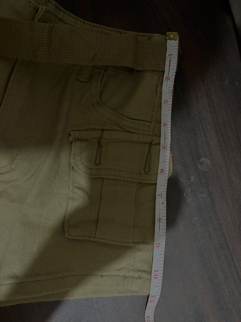 Khaki cargo shorts with attached belt (Category: Shorts) located in Liloan. Submitted by betchangel (Listing ID 1469680285, Image 3). Description: - Color: Khaki - Material: Sturdy cotton - Features: Side utility pockets and front button closure - Includes: Matching fabric belt and waistband belt loops - Styling: Perfect to pair with basic tees or tanks.