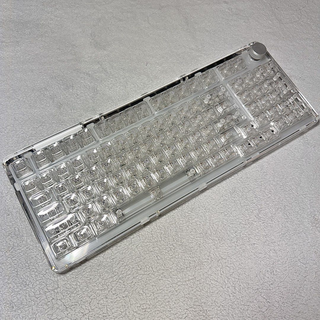 KiiBOOM Phantom 98 Crystal Keyboard (Category: Computer Keyboard) located in Paranaque City. Submitted by hershey_august (Listing ID 1469679447, Image 2). Description: - Model: KiiBOOM Phantom 98 mechanical keyboard - Design: Full clear transparent acrylic body with matching transparent keycaps - Features: Crystal volume knob and fully assembled layout including a numeric keypad - Lighting: Vibrant RGB backlit circuit board visible through the tr