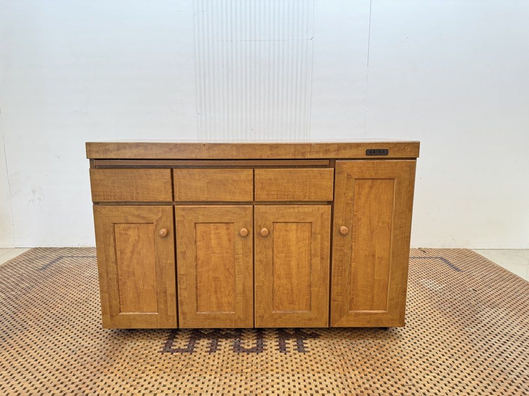 Kitchen Counter (Category: Shelves, Cabinets & Racks) located in Quezon City. Submitted by matetdevis13 (Listing ID 1469602068, Image 1). Description: Wooden Kitchen Counter Cabinet with Pull-Out Worktop & Built-In Outlet Price: 9,500 L47 x W16.5 x H30.5 In good condition Code JMD28-M74 It has 3 drawers, multiple cabinet compartments, adjustable/storage shelves, a pull-out work surface, and a built-in electrical outlet, making it suitable as a ki