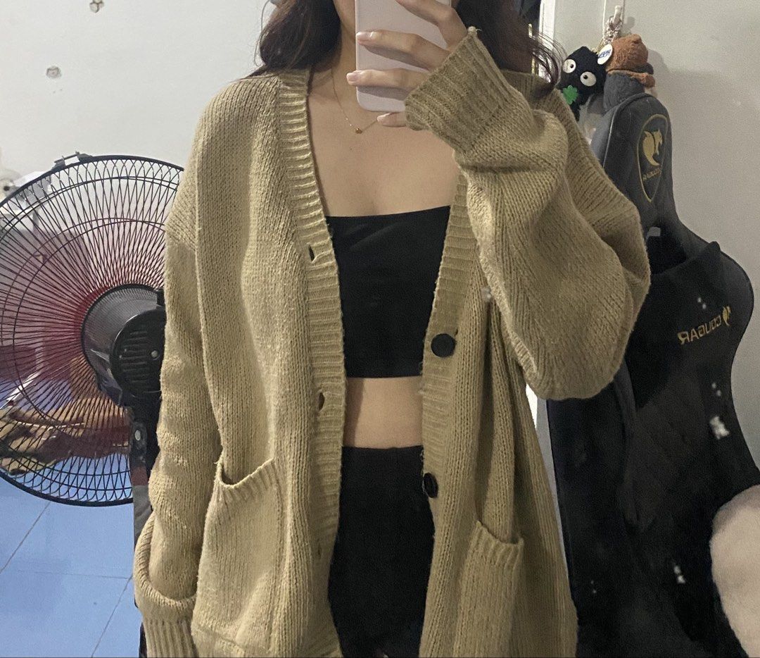 Knit Button-Up Cardigan Brown (Category: Coats, Jackets and Outerwear) located in Bulacan. Submitted by nonu_sells (Listing ID 1469686497, Image 2). Description: - Color: Soft brown - Fit: Oversized and comfortable - Neckline: V-neck with black button-down front - Pockets: Two roomy waist patch pockets - Details: Long sleeves with ribbed cuffs and hem - Ideal for: Layering on cooler days.