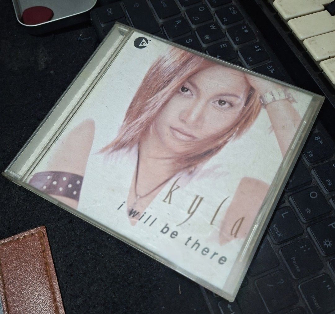 Kyla I Will Be There Audio CD Album (Category: CDs & DVDs) located in Manila. Submitted by djonathannagtalon-55936 (Listing ID 1469581076, Image 1). Description: Original Kyla audio CD titled I Will Be There, released in 2004 by EMI Philippines. Includes 15 tracks such as Someone To Love, Human Nature, and Because Of You. Standard jewel case packaging with front cover artwork and complete tracklist on the back. Case shows some light surface scrat