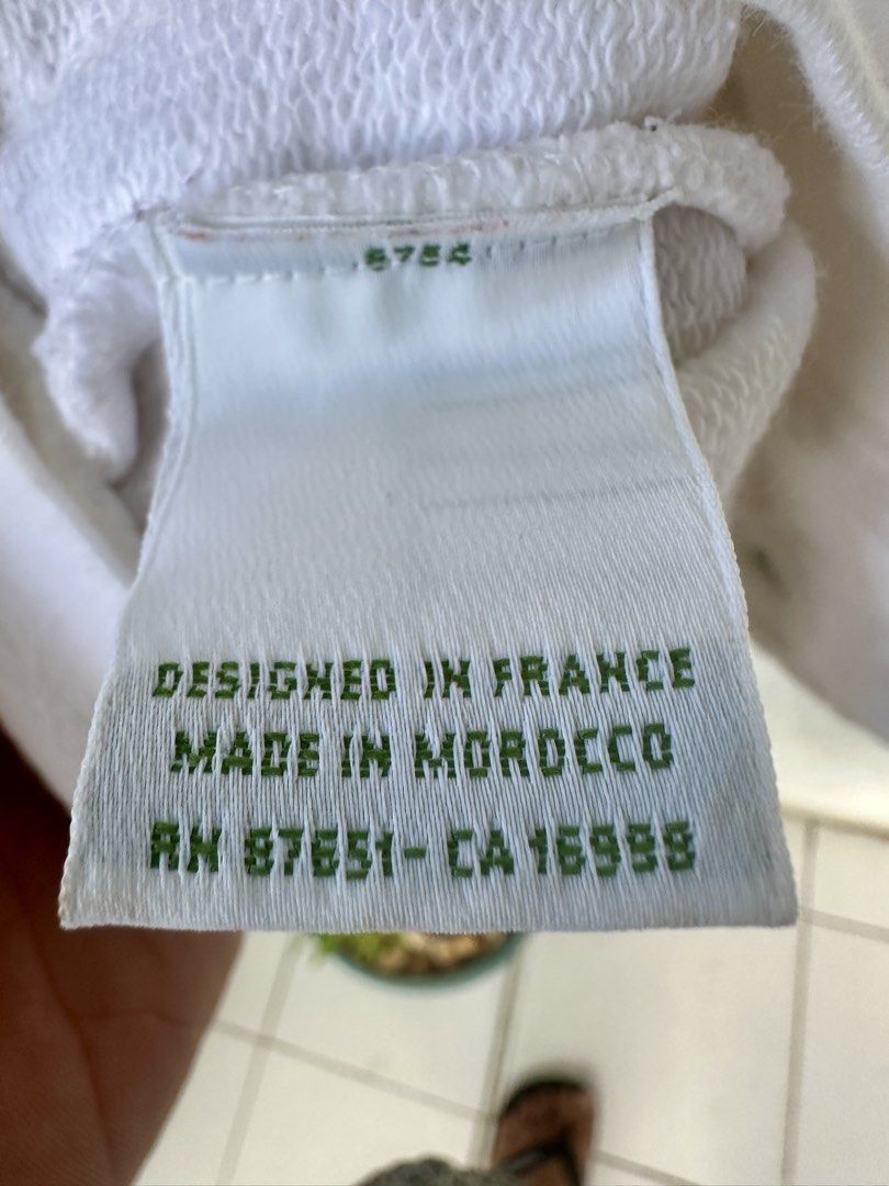 Lacoste (Category: Coats, Jackets and Outerwear) located in Cordova. Submitted by thrifttripbyreg (Listing ID 1469698773, Image 3). Description: Lacoste V-neck cardigan featuring black or dark contrasting tipping on the neckline and pockets, complete with the classic green crocodile logo on the chest..