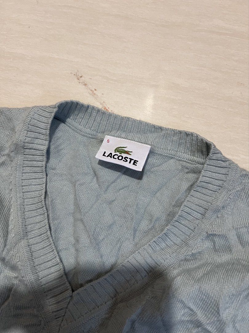 Lacoste Argyle V-Neck Sweater Blue Size 5 (Category: Longsleeves) located in Zamboanga. Submitted by safe.haimer (Listing ID 1469684862, Image 3). Description: - Brand: Lacoste - Design: Blue argyle gradient pattern (light blue to dark navy) - Material: 100% wool - Size: Tagged Size 5 (fits Korean Size 105 / XL) - Features: V-neck, long sleeves, ribbed cuffs and hem - Condition: Excellent, clean inner label and intact tags.