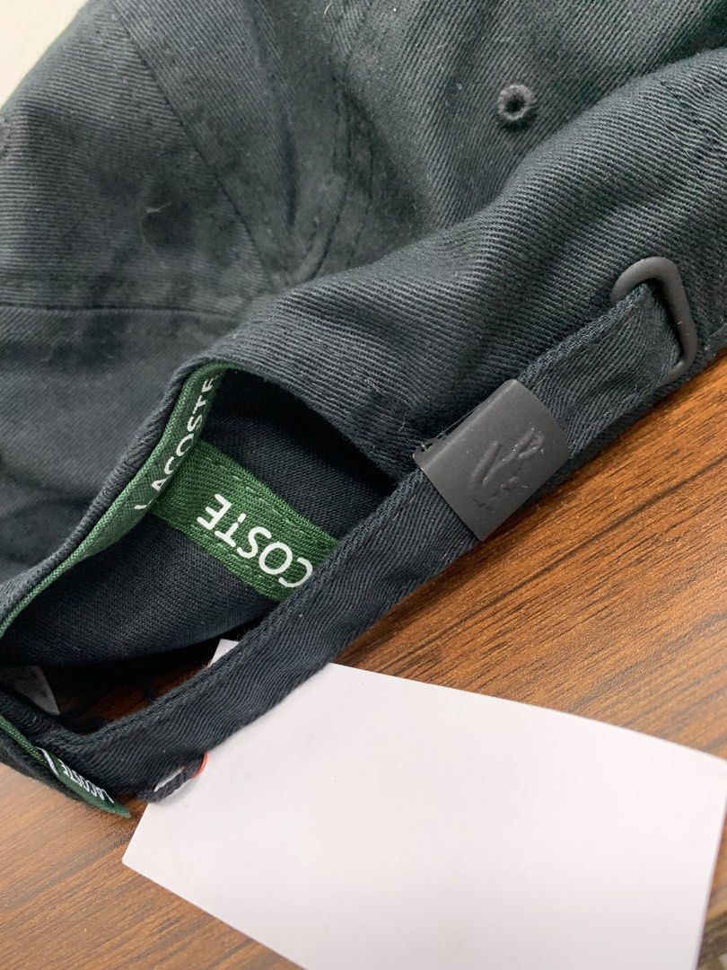 Lacoste Black Baseball Cap (Category: Caps & Hats) located in Cavite. Submitted by jeromeaba95864 (Listing ID 1469749723, Image 3). Description: - Brand: Lacoste - Color: Classic Black - Material: Premium cotton twill - Design: Iconic embroidered green crocodile patch on the front - Fit: Adjustable strap closure with metal hardware (One size fits most) - Condition: Brand new with original retail tag attached - Details: Features interior branding 