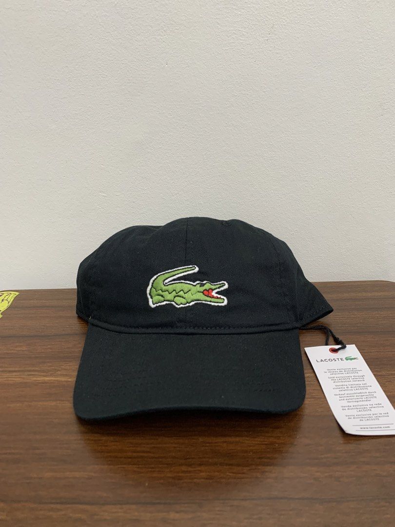Lacoste Black Baseball Cap (Category: Caps & Hats) located in Cavite. Submitted by jeromeaba95864 (Listing ID 1469749723, Image 1). Description: - Brand: Lacoste - Color: Classic Black - Material: Premium cotton twill - Design: Iconic embroidered green crocodile patch on the front - Fit: Adjustable strap closure with metal hardware (One size fits most) - Condition: Brand new with original retail tag attached - Details: Features interior branding 