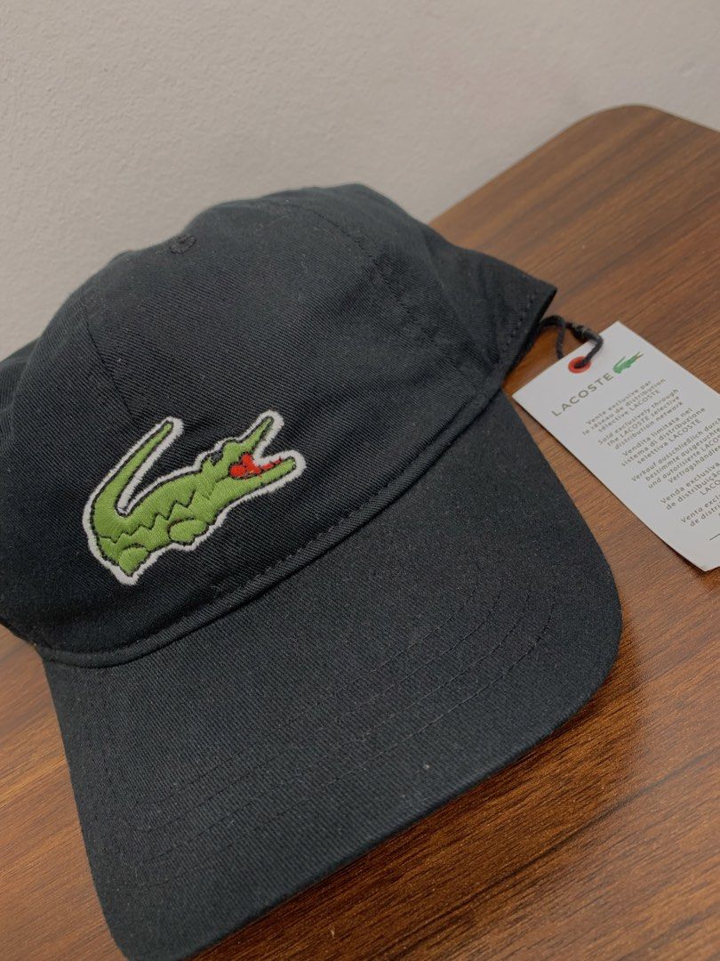 Lacoste Black Baseball Cap (Category: Caps & Hats) located in Cavite. Submitted by jeromeaba95864 (Listing ID 1469749723, Image 2). Description: - Brand: Lacoste - Color: Classic Black - Material: Premium cotton twill - Design: Iconic embroidered green crocodile patch on the front - Fit: Adjustable strap closure with metal hardware (One size fits most) - Condition: Brand new with original retail tag attached - Details: Features interior branding 