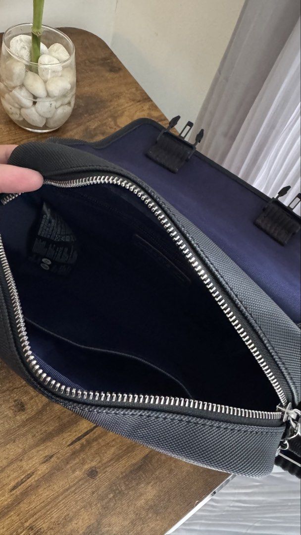 Lacoste Black Messenger / Crossbody Bag (Category: Sling Bags) located in Manila. Submitted by spicybean (Listing ID 1469703134, Image 2). Description: Lacoste Black Messenger Bag • Authentic Lacoste • Very good condition • Black textured exterior • Adjustable crossbody strap • Flap closure with two silver-tone buckles • Secure zippered main compartment • Interior pockets for essentials • Subtle embroidered Lacoste crocodile logo • Clean inside a