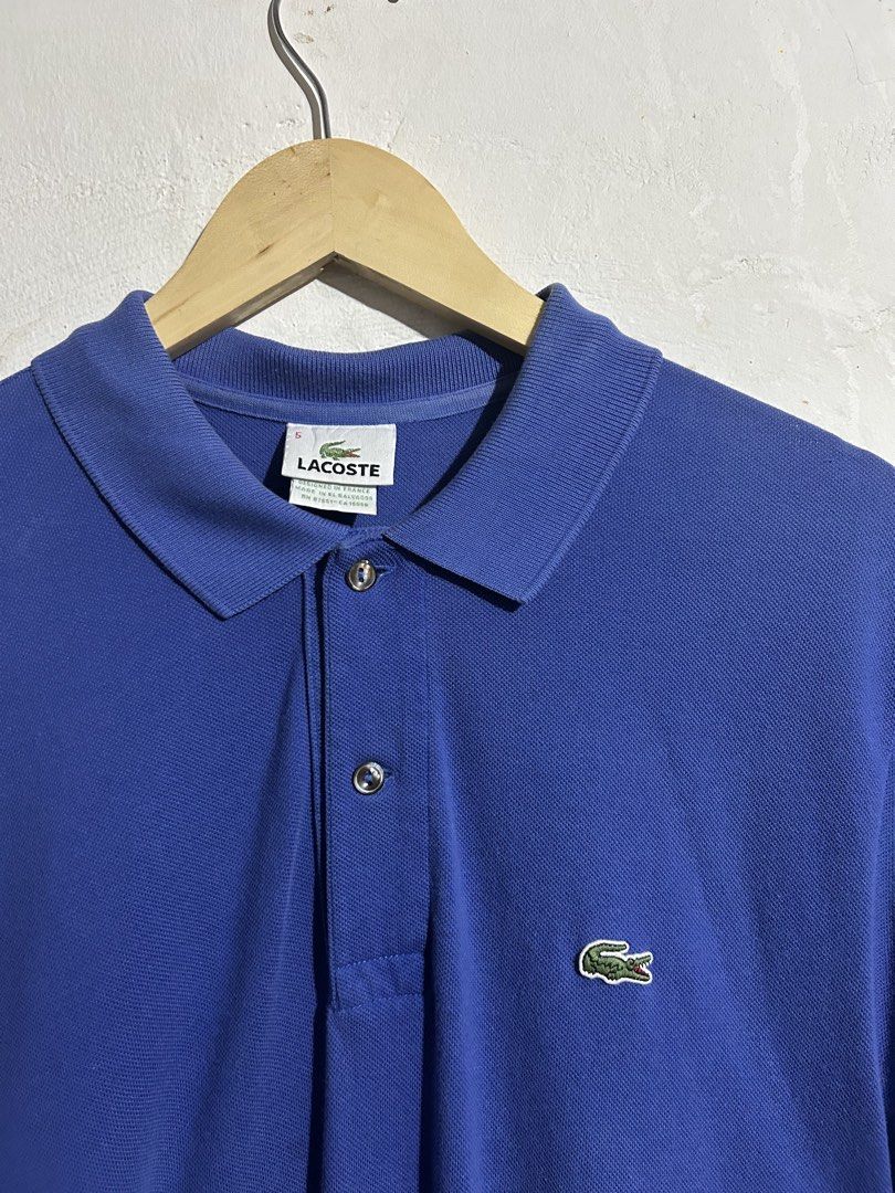Lacoste Blue Polo Shirt Size 5 (Category: Tshirts & Polo Shirts ) located in Manila. Submitted by romnick907 (Listing ID 1469705882, Image 2). Description: - Authentic blue Lacoste polo shirt - Size: 5 (Made in El Salvador by Devanlay S.A.) - Material: Clean and comfortable cotton piqué - Design: Classic collar with a 2-button placket - Branding: Iconic embroidered green crocodile logo on the chest - Condition: Great staple piece, perfect for cas