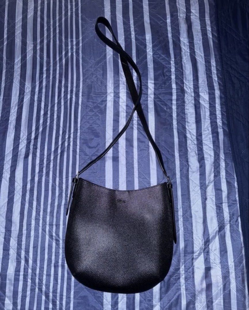 LACOSTE Chantaco Crossbody Bag (Category: Shoulder Bags) located in Paranaque City. Submitted by beamiral (Listing ID 1469726586, Image 3). Description: RFS: Was not able to use this ever and sayang naman since super bago pa. • Bought this for P11,950 • This was purchased at Lacoste Glorietta. • No scratches. Never been used. • Comes with the original dust bag • Enclosed with a magnetic button • Has a lot of pockets inside and out.