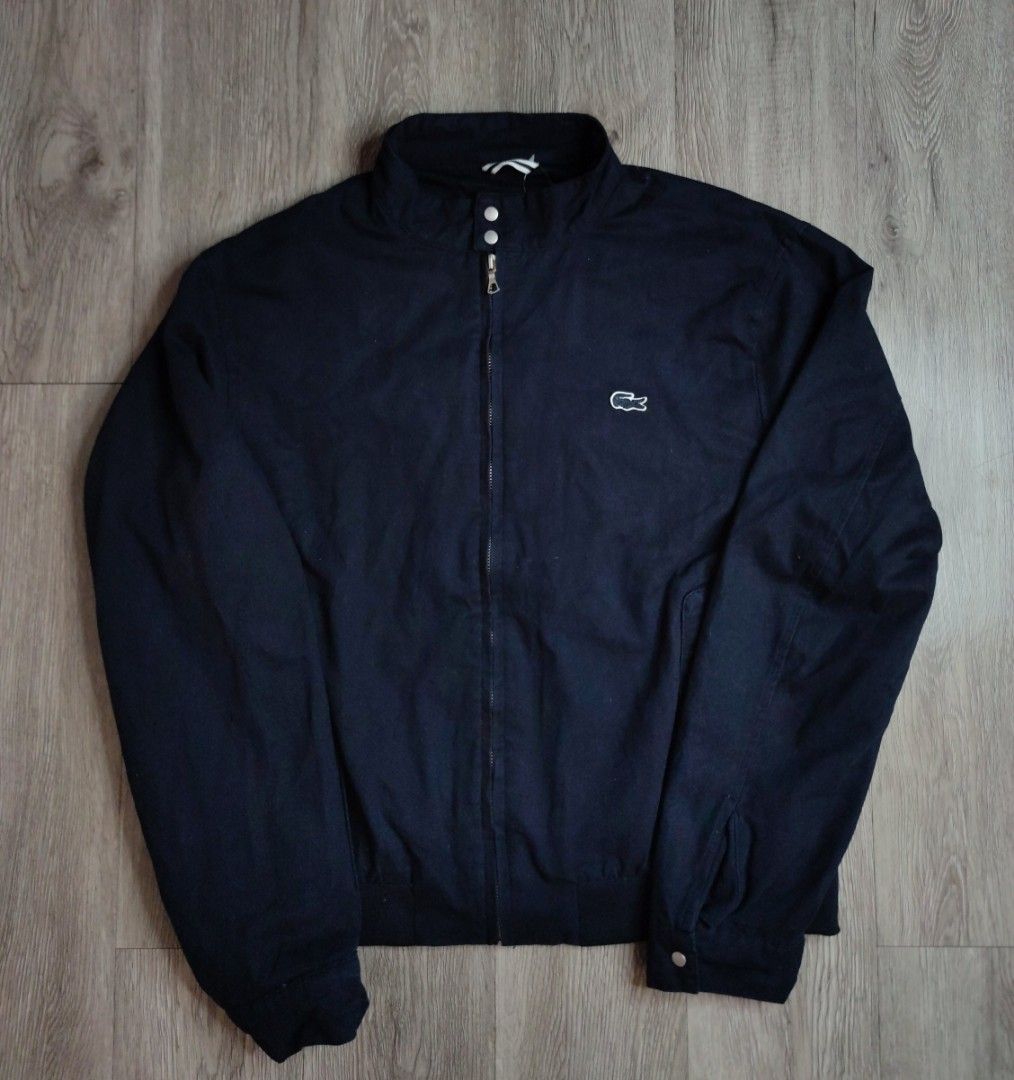 Lacoste Harrington Navy Blue Jacket BH3921 (Category: Coats, Jackets and Outerwear) located in Pasig City. Submitted by vintage.thrifttph (Listing ID 1469651752, Image 1). Description: - Brand: Lacoste - Style Number: BH3921 - Condition: Used 9/10 condition - Color: Solid Navy - Size: 23 width 25 length (boxy fit) - Details: Full zip front, mock collar with snap buttons, comfortable mesh lining, ribbed cuffs and hem - Features the iconic Lacoste 