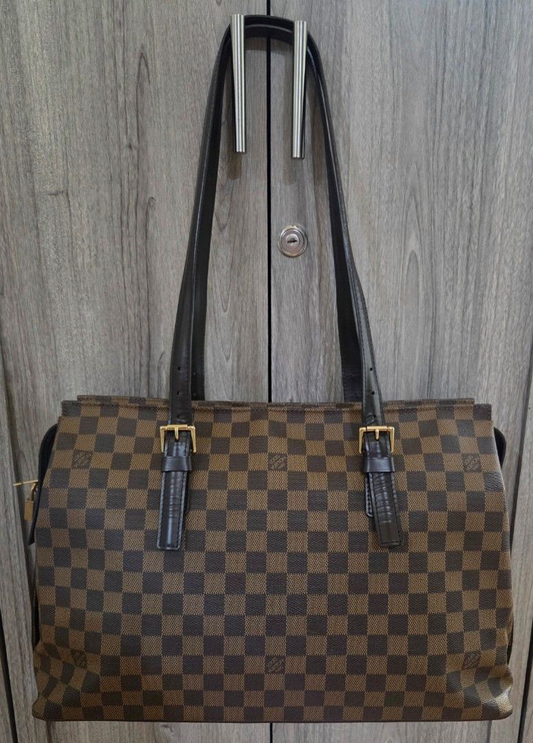LV Chelsea Tote (Category: Luxury Bags & Wallets) located in Manila. Submitted by vra.luxe (Listing ID 1469701295, Image 1). Description: For Sale! 👜 Louis Vuitton Chelsea Damier Ebene ✨ Condition: Slightly Used — Rank AB to Near A 👜 Bag Description: Classic Louis Vuitton Chelsea in the timeless Damier Ebene canvas with dark brown leather trim, gold-tone hardware, and a spacious interior lined in red textile. Features a secure top zipper closur