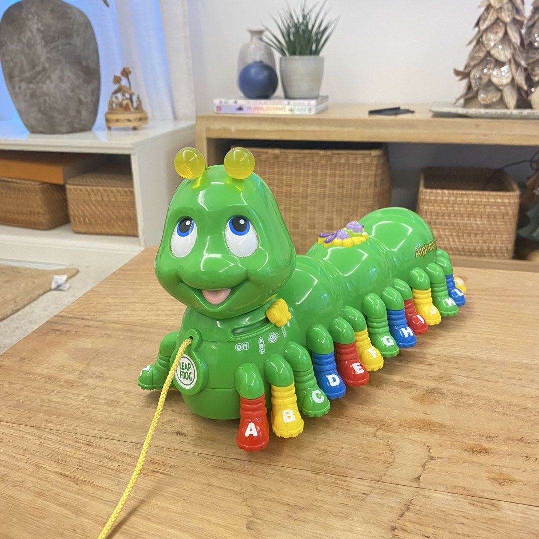 LeapFrog Alphapup Alphabet Caterpillar Pull Toy (Category: Educational & Learning Toys) located in Manila. Submitted by pinklilo (Listing ID 1469651464, Image 1). Description: - Interactive LeapFrog AlphaPup pull toy in vibrant green - Features colorful A-Z letter shoes for alphabet learning - Mode switch for switching between learning and music settings - Pull string with official LeapFrog logo medallion - Smooth-rolling wheels for active play -