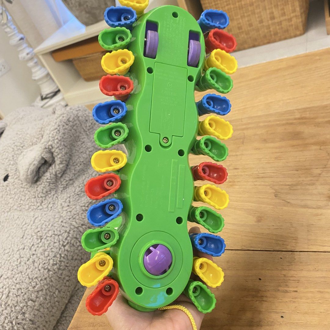 LeapFrog Alphapup Alphabet Caterpillar Pull Toy (Category: Educational & Learning Toys) located in Manila. Submitted by pinklilo (Listing ID 1469651464, Image 2). Description: - Interactive LeapFrog AlphaPup pull toy in vibrant green - Features colorful A-Z letter shoes for alphabet learning - Mode switch for switching between learning and music settings - Pull string with official LeapFrog logo medallion - Smooth-rolling wheels for active play -
