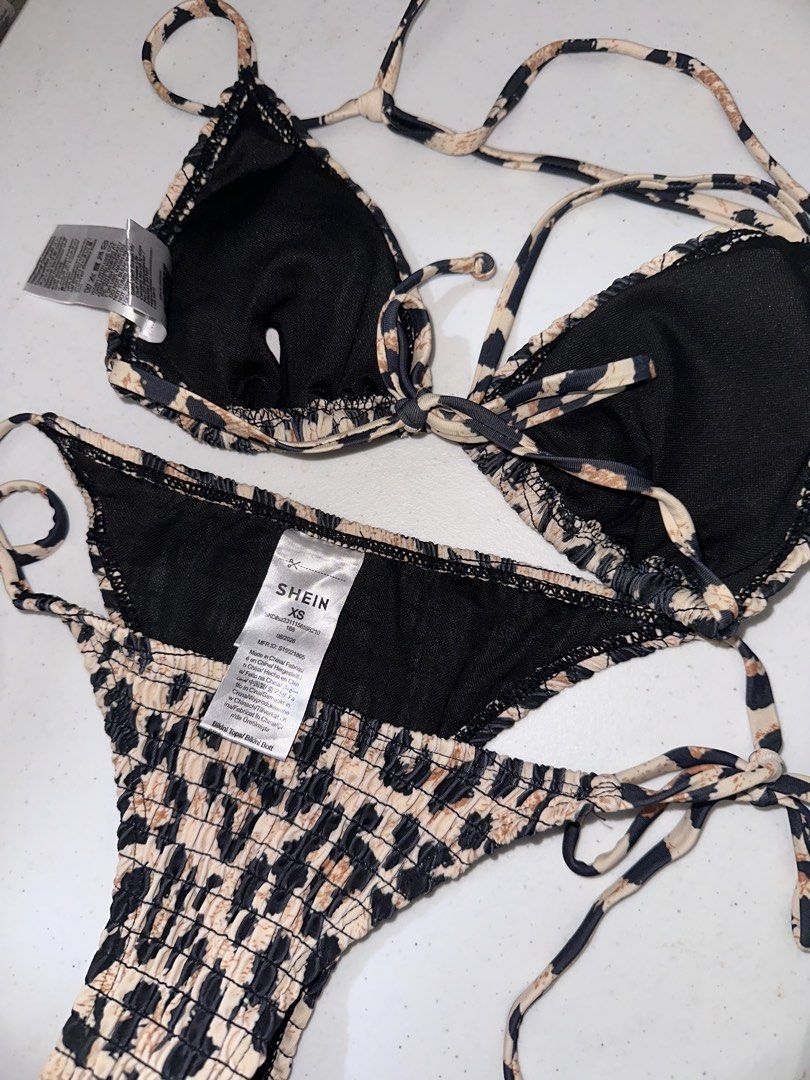 Leopard Print Triangle Bikini Set (Category: Bikinis & Swimsuits) located in Pasig City. Submitted by prelovedbysco (Listing ID 1469691015, Image 3). Description: - Brand: Shein - Condition: Brand new with tags (never worn) - Size: XS, fits 32-34A cup - Pattern/Texture: Leopard print with all-over smocked fabric - Design: Triangle top with string ties, matching side-tie bottoms, and black contrast trim RFS: used once for beach trip, only bought t