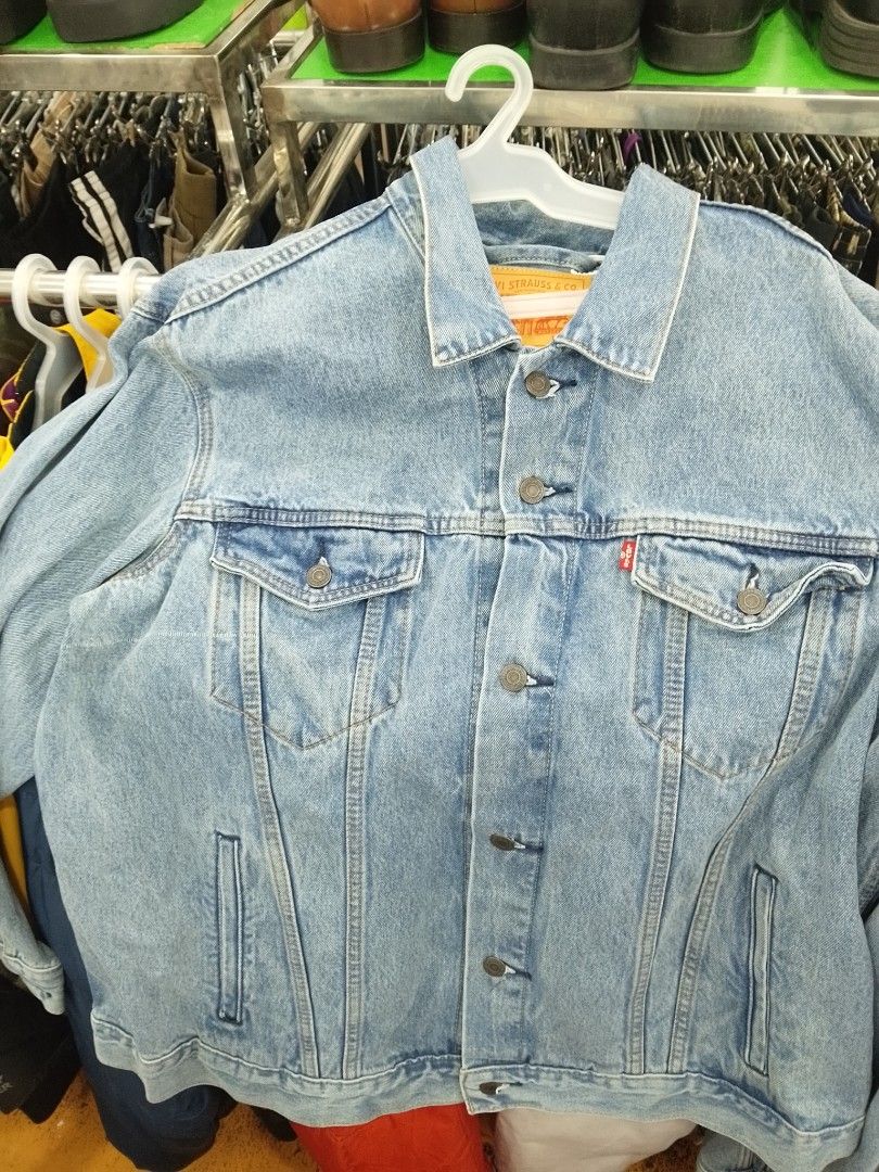 Levi's Classic Blue Denim Jacket (Category: Coats, Jackets and Outerwear) located in Manila. Submitted by afreemf (Listing ID 1469643874, Image 2). Description: - Brand: Levi's - Wash: Medium blue - Closure: Traditional button-up front with metallic shank buttons - Pockets: Two chest flap pockets and convenient side welt pockets - Details: Iconic red tab on the left chest pocket and classic collar - Material: Durable cotton denim - Condition: Gre