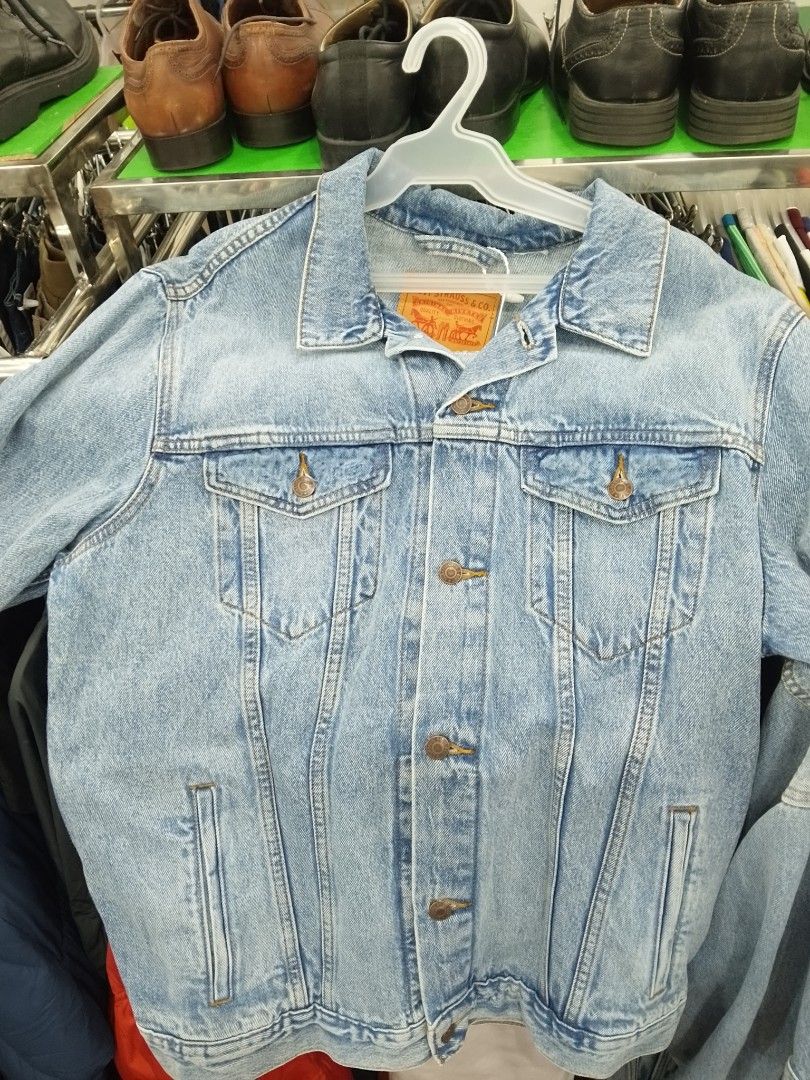 Levi's Classic Blue Denim Jacket (Category: Coats, Jackets and Outerwear) located in Manila. Submitted by afreemf (Listing ID 1469643874, Image 3). Description: - Brand: Levi's - Wash: Medium blue - Closure: Traditional button-up front with metallic shank buttons - Pockets: Two chest flap pockets and convenient side welt pockets - Details: Iconic red tab on the left chest pocket and classic collar - Material: Durable cotton denim - Condition: Gre