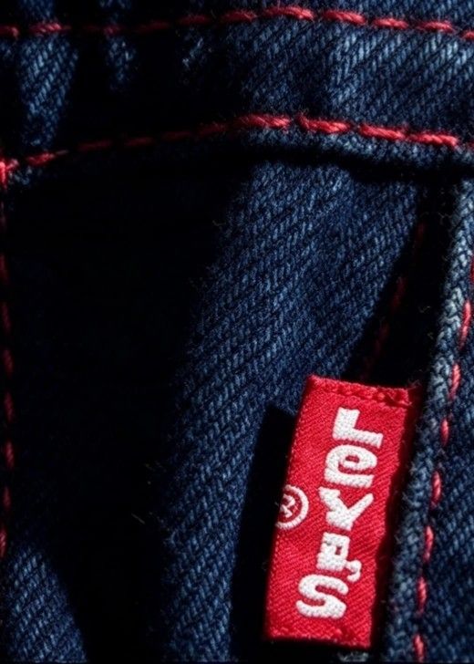 Levi's Dark Wash Denim Jacket with Red Stitching (Category: Coats, Jackets and Outerwear) located in Caloocan City. Submitted by grandcloud.a0efa7 (Listing ID 1469614825, Image 3). Description: - Brand: Levi's - Color/Wash: Dark blue with a rigid denim feel - Distinctive Details: Eye-catching red contrast stitching throughout - Hardware: Silver metal buttons stamped with the brand name - Pockets: Dual chest flap pockets with the classic red tab -