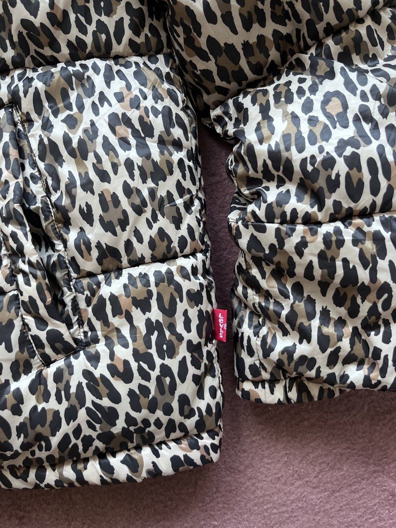 Levi's Leopard Print Puffer Jacket (Category: Coats, Jackets and Outerwear) located in Mandaluyong City. Submitted by chienneclassique (Listing ID 1469688760, Image 3). Description: - Brand: Levi's - Design: Bold all-over leopard print with contrasting black velvet collar and yoke panel - Closure: Full front zip with dual zip pulls and high stand-up collar for extra warmth - Details: Signature Levi's logo patch on the chest and classic red tab on