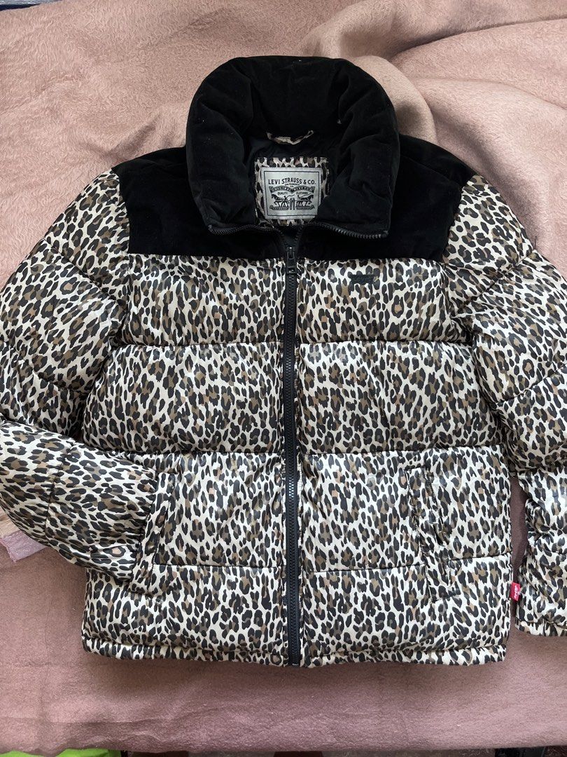Levi's Leopard Print Puffer Jacket (Category: Coats, Jackets and Outerwear) located in Mandaluyong City. Submitted by chienneclassique (Listing ID 1469688760, Image 1). Description: - Brand: Levi's - Design: Bold all-over leopard print with contrasting black velvet collar and yoke panel - Closure: Full front zip with dual zip pulls and high stand-up collar for extra warmth - Details: Signature Levi's logo patch on the chest and classic red tab on