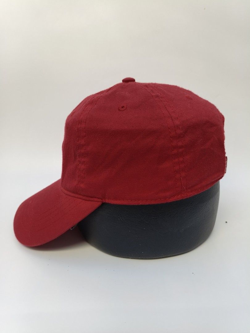 Levi's Red Cap (Category: Caps & Hats) located in Imus. Submitted by grindhouse.thriftshop (Listing ID 1469601648, Image 3). Description: - Brand: Levi's - Color: Bright red with white embroidered logo patch - Design: Classic 6-panel with curved brim and breathable eyelets - Fit: Adjustable strap at the back for a custom fit - Condition: Clean fabric, minimal wear, great for everyday casual use.