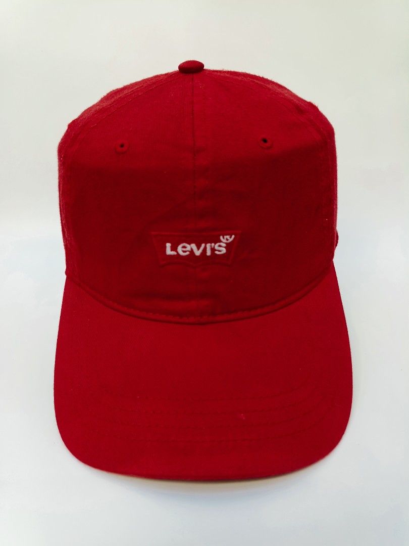 Levi's Red Cap (Category: Caps & Hats) located in Imus. Submitted by grindhouse.thriftshop (Listing ID 1469601648, Image 1). Description: - Brand: Levi's - Color: Bright red with white embroidered logo patch - Design: Classic 6-panel with curved brim and breathable eyelets - Fit: Adjustable strap at the back for a custom fit - Condition: Clean fabric, minimal wear, great for everyday casual use.