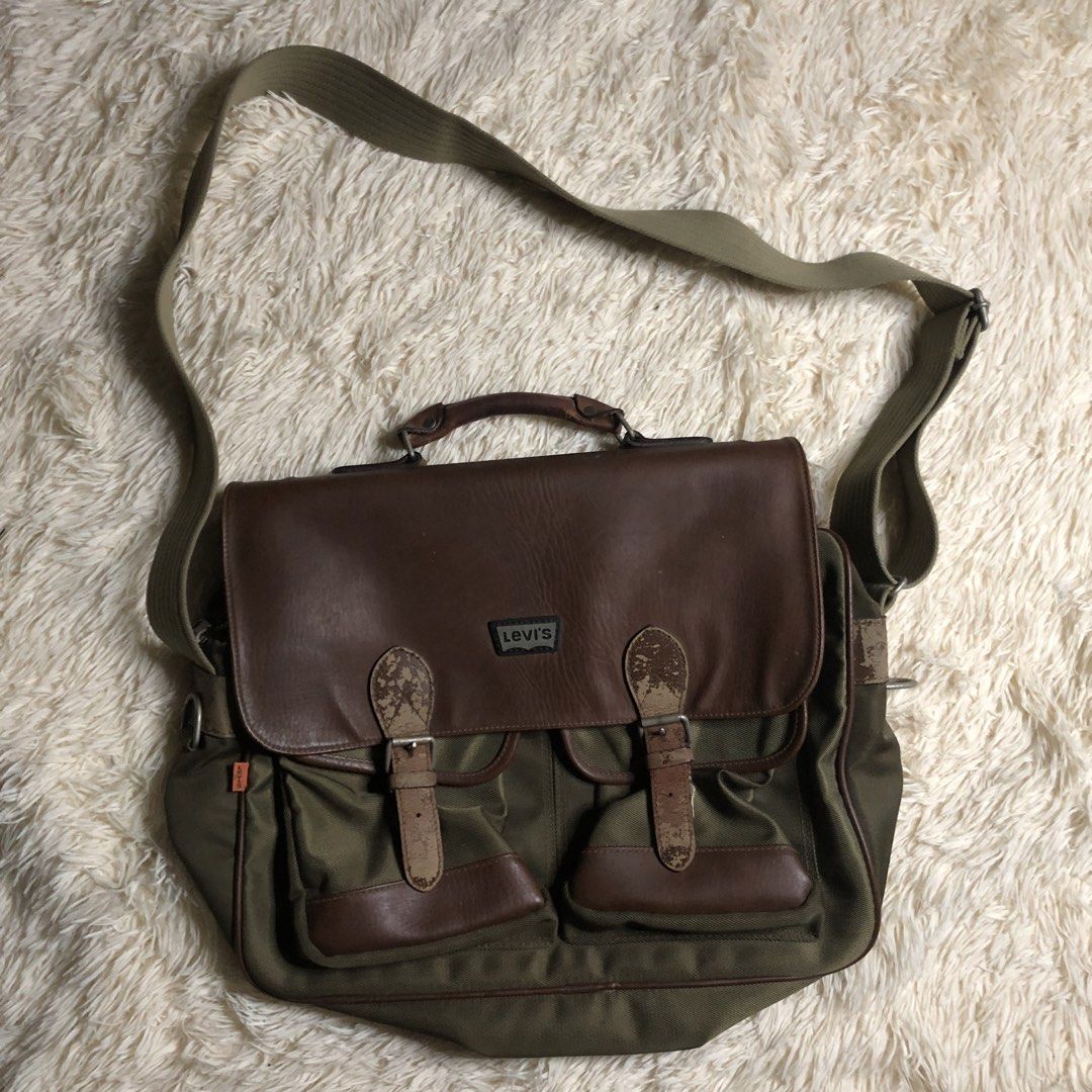 Levi's Vintage Orange Tab Messenger Bag (Category: Sling Bags) located in Maria Aurora. Submitted by kylerikathriftshop101010 (Listing ID 1469713063, Image 1). Description: issues sa leather besides that wala na- Brand: Levi's (Made in Japan) - Material: Green canvas with brown faux leather trim - Compartments: Secure main zip closure, dual front buckle pockets, and rear exterior zipper pocket - Carry options: Adjustable canvas shoulder strap and