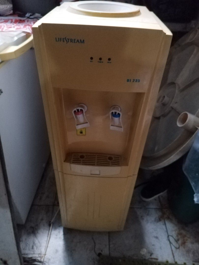 Lifestream UI 235 Standing Water Dispenser (Category: Water Purifiers & Dispensers) located in Makati City. Submitted by nerydevera (Listing ID 1469756593, Image 2). Description: - Brand/Model: Lifestream UI 235 floor-standing water dispenser - Color: Bright yellow and white exterior - Water Options: Dual taps for hot and cold water - Loading Type: Standard top-loading design for water jugs - Features: Removable front drip tray and power indicato