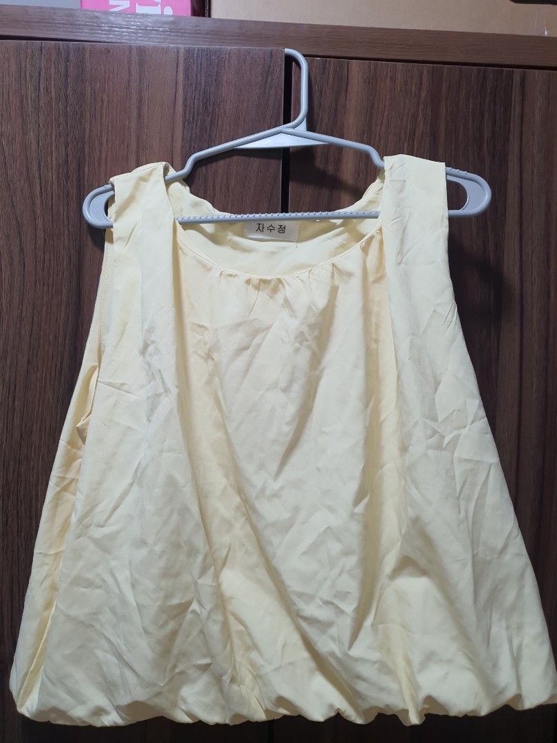 Light Yellow Sleeveless Blouse (Category: Sleeveless) located in Taguig. Submitted by ymeene (Listing ID 1469603499, Image 1). Description: - Color: Light yellow - Material: Soft, light, and airy fabric - Design: Sleeveless with a classic round neckline - Style: Simple everyday piece, easy to match with jeans or skirts - Condition: Wrinkled from storage, just needs a quick iron.