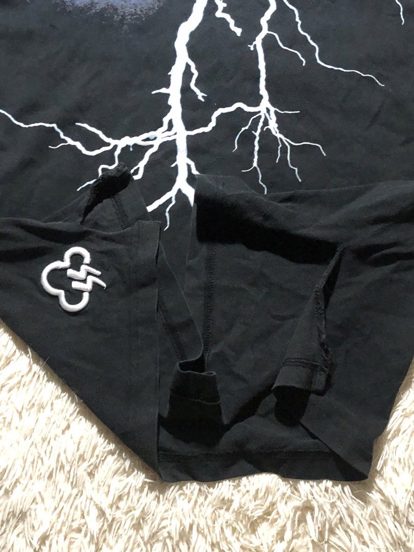 Lightning Graphic Shirt Distressed (Category: Tshirts & Polo Shirts ) located in Maria Aurora. Submitted by kylerikathriftshop101010 (Listing ID 1469718090, Image 3). Description: 24 by 29 distressing good quality yung tela - Color: Black - Style: Short sleeve crew neck t-shirt with a standard straight hem - Design: Large white and blue lightning bolt graphic on the back - Detail: Small embroidered cloud and lightning logo patch near the bottom h