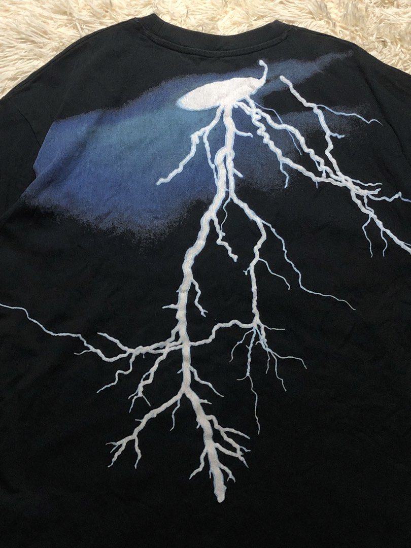 Lightning Graphic Shirt Distressed (Category: Tshirts & Polo Shirts ) located in Maria Aurora. Submitted by kylerikathriftshop101010 (Listing ID 1469718090, Image 2). Description: 24 by 29 distressing good quality yung tela - Color: Black - Style: Short sleeve crew neck t-shirt with a standard straight hem - Design: Large white and blue lightning bolt graphic on the back - Detail: Small embroidered cloud and lightning logo patch near the bottom h