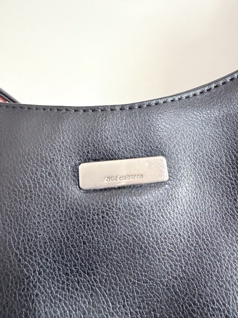 Liz Claiborne Black Shoulder Bag (Category: Shoulder Bags) located in Quezon City. Submitted by angelajuliet__ (Listing ID 1469591051, Image 3). Description: - Brand: Liz Claiborne - Color: Classic Black - Material: Pebbled faux leather with silver-tone hardware and front logo plaque - Style: Hobo shoulder bag with single strap - Closure: Secure zip top - Interior: Clean lining - Condition: Timeless vintage piece.
