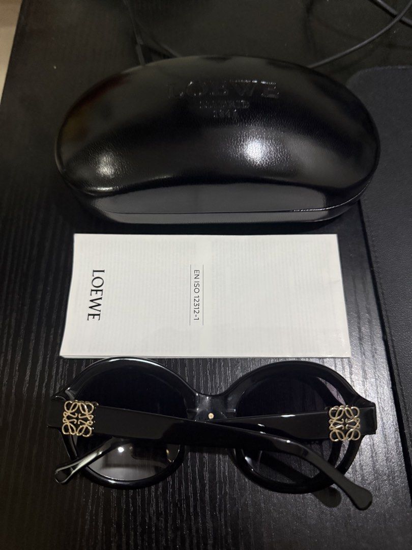 Loewe Black Round Sunglasses with Case (Category: Sunglasses & Eyewear) located in Manila. Submitted by caeln (Listing ID 1469693871, Image 3). Description: - Brand: Loewe - Style: Black round sunglasses with gradient black lenses - Details: Iconic gold Anagram logo hardware on both temples - Material: Premium acetate frames, made in Italy - Inclusions: Original black leather hard case and care booklet - Condition: Pristine, well-maintained luxur
