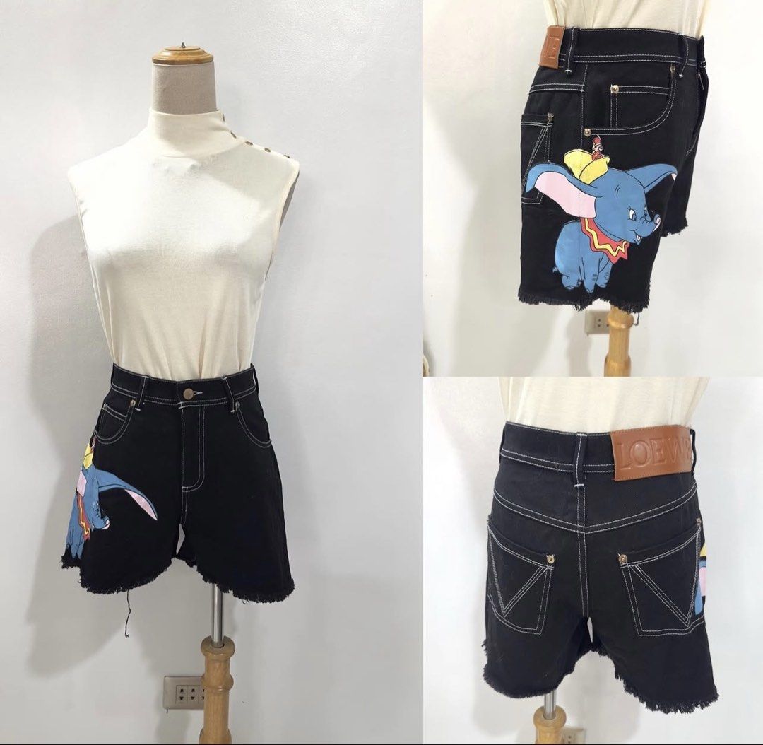 Loewe Dumbo Denim Shorts Black (Category: Shorts) located in Bacolod City. Submitted by bhabissagal-05763 (Listing ID 1469595799, Image 3). Description: - Authentic Loewe x Disney Dumbo collab denim shorts in black - Playful Dumbo graphic printed on the side leg - Trendy raw frayed hem and white contrast stitching - Iconic Loewe Anagram logo on metal hardware and embossed leather back patch - Mid-rise, relaxed fit for everyday comfort - Made in I