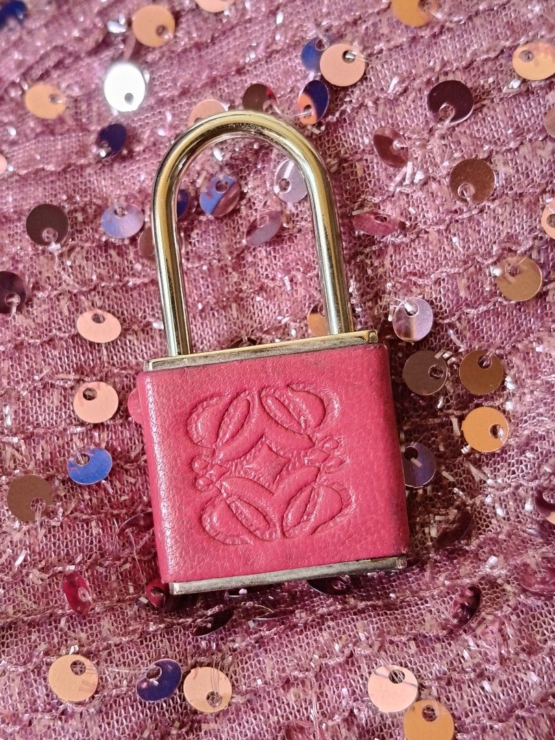 Loewe pink leather padlock charm accessory (Category: Charms) located in Santa Rosa. Submitted by iammarien2nette (Listing ID 1469582733, Image 1). Description: - Authentic Loewe pink leather padlock charm - Features silver-tone hardware with embossed iconic Anagram logo - LOEWE text stamped on the bottom plate - Working lock mechanism with swivel shackle - Compact size, ideal for bags or keys - Condition: Minimal wear on the metal base - Selling