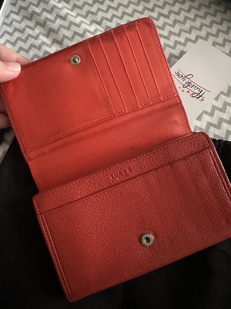 Loewe Red Leather Long Wallet with Lock Charm (Category: Wallets & Card holders) located in Antipolo. Submitted by prelovedcloseta (Listing ID 1469610856, Image 3). Description: - Brand: Loewe - Style: Long wallet / continental wallet - Color: Rich red with gold-tone hardware - Material: Premium textured leather with soft leather lining - Closure: Secure snap button closure - Interior: Multiple card slots and structured accordion compartments - E