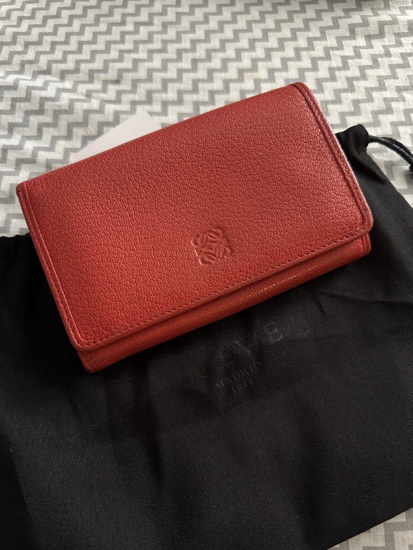 Loewe Red Leather Long Wallet with Lock Charm (Category: Wallets & Card holders) located in Antipolo. Submitted by prelovedcloseta (Listing ID 1469610856, Image 1). Description: - Brand: Loewe - Style: Long wallet / continental wallet - Color: Rich red with gold-tone hardware - Material: Premium textured leather with soft leather lining - Closure: Secure snap button closure - Interior: Multiple card slots and structured accordion compartments - E