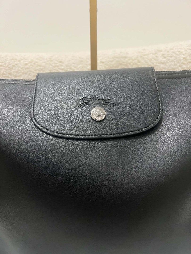 Longchamp Black Leather Shoulder Bag (Category: Shoulder Bags) located in Paoay. Submitted by rvf1230 (Listing ID 1469580945, Image 3). Description: - Brand: Longchamp - Material: Premium black leather with clean finish - Closure: Top zip with front flap and snap button - Strap: Adjustable for a comfortable fit - Details: Stamped logo on front flap and branded hardware - Inclusions: Original Longchamp dust bag included.