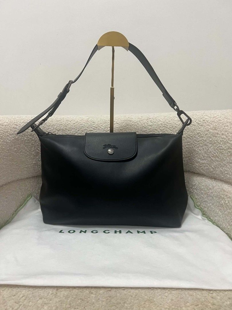 Longchamp Black Leather Shoulder Bag (Category: Shoulder Bags) located in Paoay. Submitted by rvf1230 (Listing ID 1469580945, Image 1). Description: - Brand: Longchamp - Material: Premium black leather with clean finish - Closure: Top zip with front flap and snap button - Strap: Adjustable for a comfortable fit - Details: Stamped logo on front flap and branded hardware - Inclusions: Original Longchamp dust bag included.