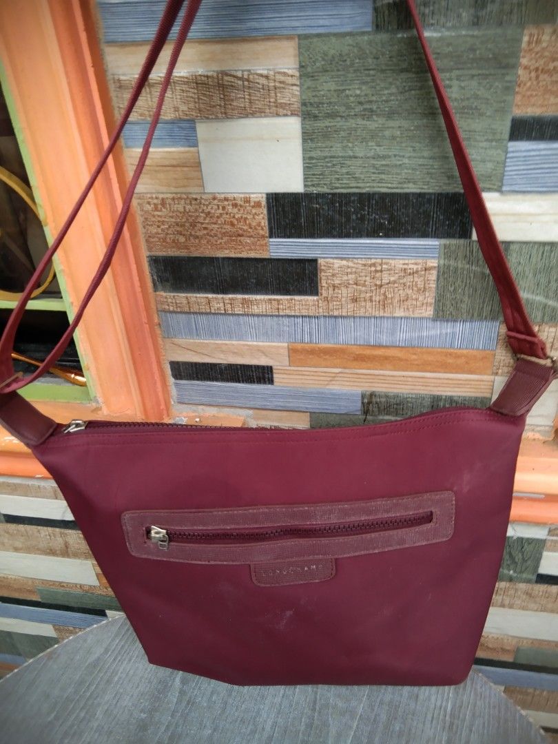 Longchamp Burgundy Crossbody Bag (Category: Cross-body Bags) located in Manila. Submitted by mysticshark-0a05e9 (Listing ID 1469756150, Image 1). Description: - Authentic Longchamp crossbody bag, proudly made in France - Elegant burgundy color with stylish textured trim accents - Crafted from signature durable nylon fabric with a secure zipper closure and metallic puller - Features a convenient exterior zip pocket and an adjustable strap for comf
